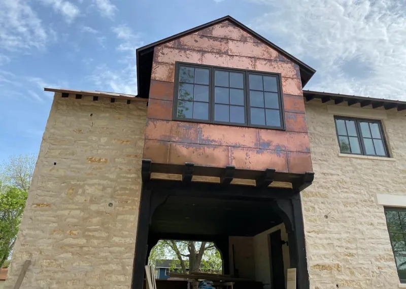 Copper metal panel facade on a stone building for Skylight Installation in Racine