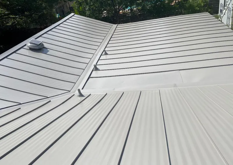 Solar attic fan installed on a metal roof for Roof Ventilation in Racine